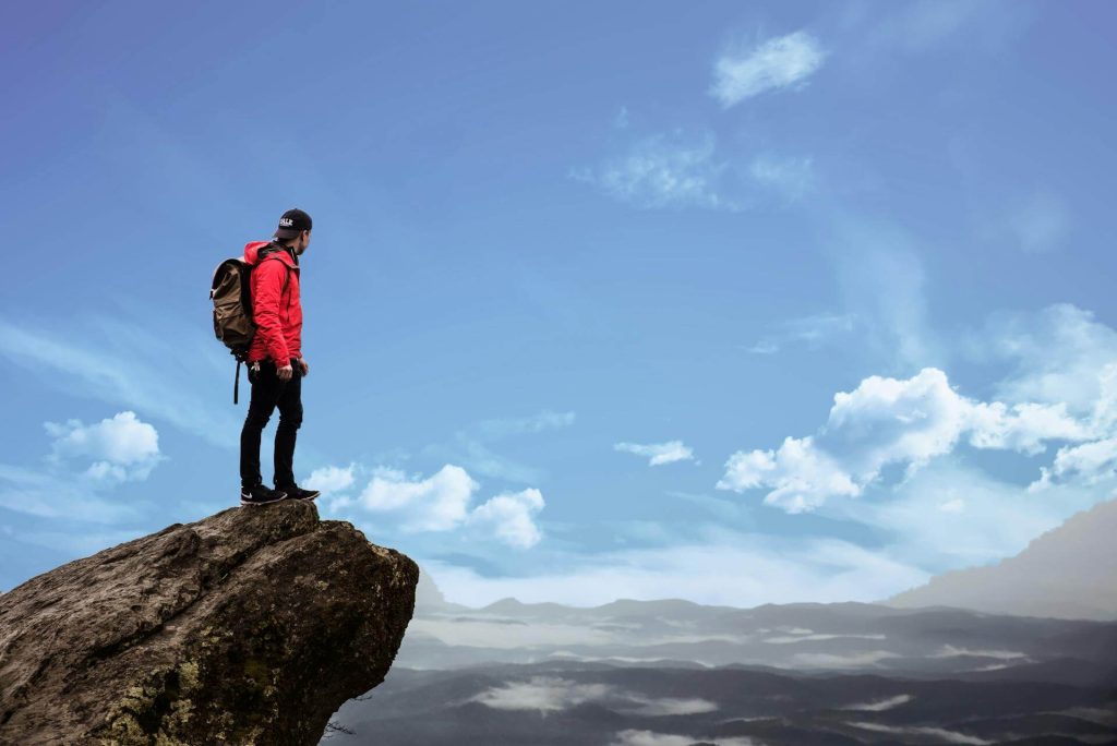A man standing on the edge of a cliff
