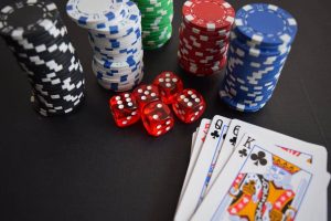 Playing cards, casino chips and red dice